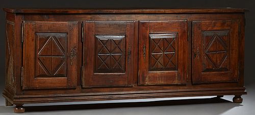 French Provincial Louis XIII Style Carved Walnut Sideboard, 19th c., the rectangular top over four fielded panel cupboard doors with incised "X" decor
