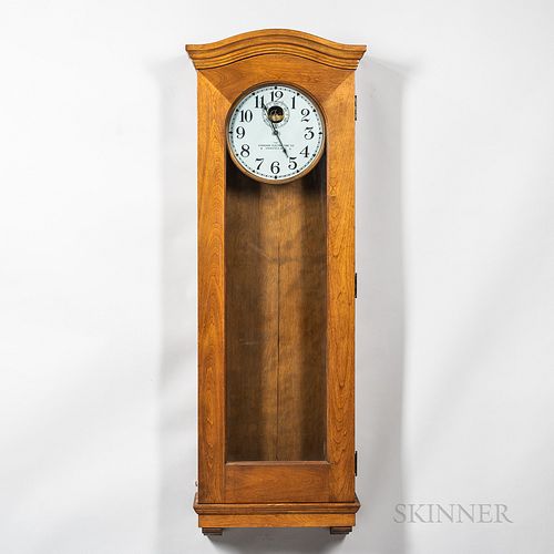 Standard Electric Time Master Clock, birch case with full-length glazed door, wood bezel surrounds the 12-in. metal roman numeral dial