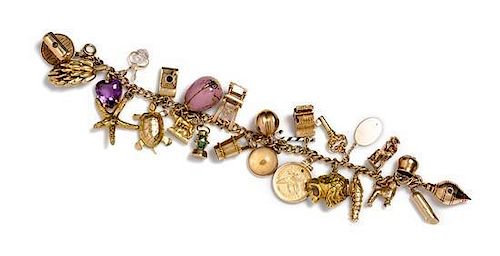 A 14 Karat Yellow Gold Charm Bracelet with 25 Attached Charms, 42.60 dwts.
