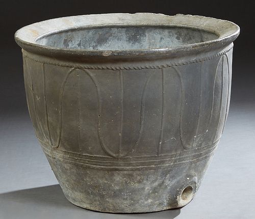 French Provincial Cast Stone Planter, early 20th c., with an everted rim over relief baluster sides, the bottom with a bung hole at the bottom on one 