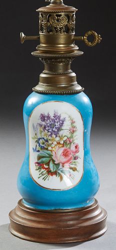 French Porcelain Oil Lamp, 19th c., with floral reserves on both sides, on a blue ground, on a stepped circular wooden base, now electrified, H.- 22 i