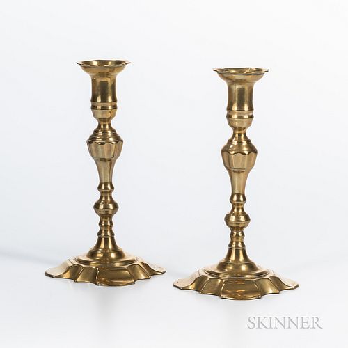 Pair of Brass Candlesticks, England, mid-18th century, with scalloped candle cups, baluster posts, and shaped quatrefoil bases, ht. 9 i
