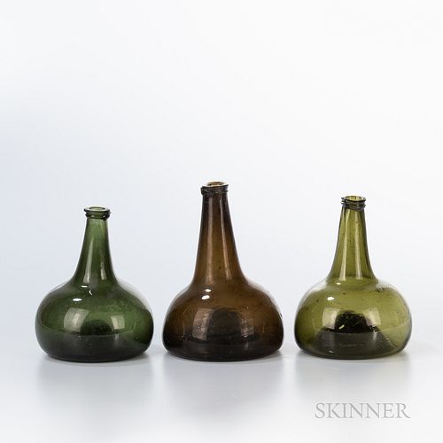 Three Blown Glass Bottles, late 18th century, with tapering necks and bulbous bases with concave bottoms, ht. to 7 3/4 in.