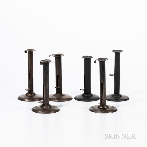 Six Iron "Hogscraper" Push-up Candlesticks, England, 19th century, of typical form, some with makers' marks on the push-up tabs, (two w