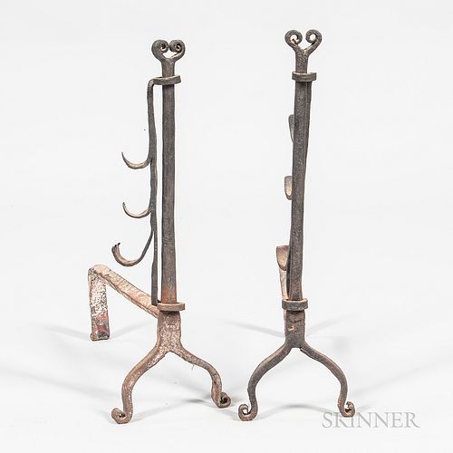 Pair of Wrought Iron Andirons, probably New England, 18th century, the ram's horn tops above posts with adjustable spit holders, on sha