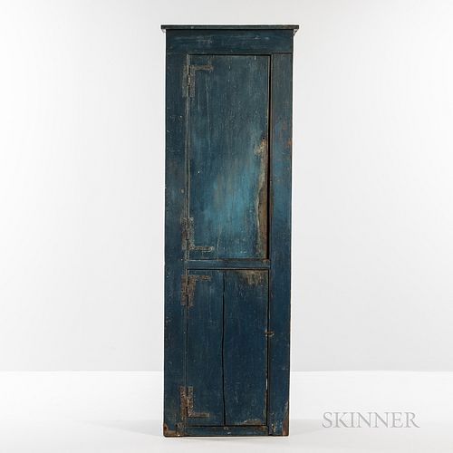 Small Blue-painted Pine Chimney Cupboard, late 18th century, the cockbeaded case of two hinged doors opening to concave shelves in the