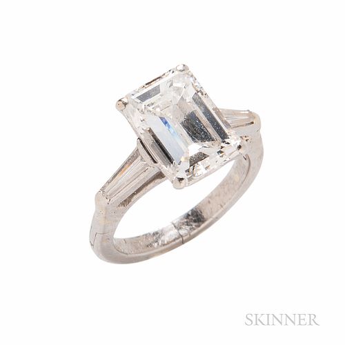Platinum and Diamond Solitaire, the emerald-cut diamond weighing 3.64 cts., flanked by tapered baguettes, size 5 1/4. Note: Accompanied