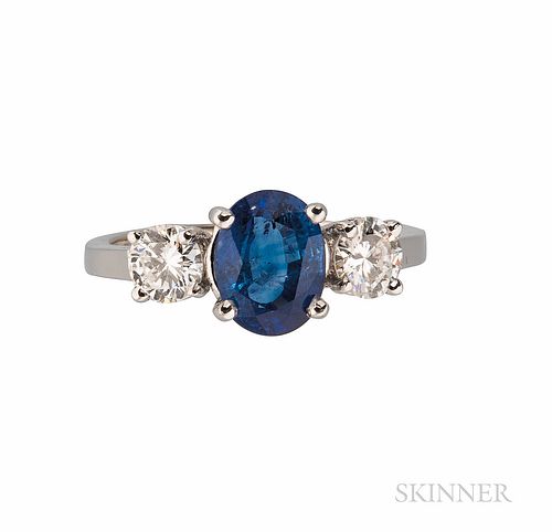 18kt White Gold, Sapphire, and Diamond Ring, set with an oval-cut sapphire measuring approx. 8.30 x 6.25 x 4.10 mm, flanked by full-cut
