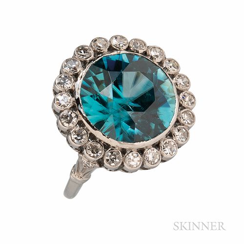 Platinum, Blue Zircon, and Diamond Ring, bezel-set with a circular-cut zircon measuring approx. 13.30 x 8.15 mm, framed by old single-c