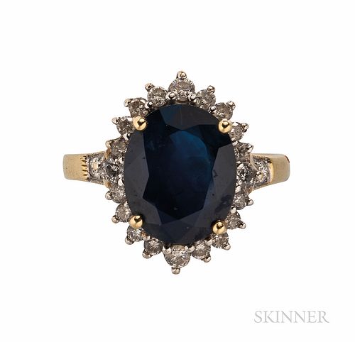 18kt Gold, Sapphire, and Diamond Ring, prong-set with an oval-cut sapphire measuring approx. 12.40 x 10.00 x 5.60 mm, framed by full-cu