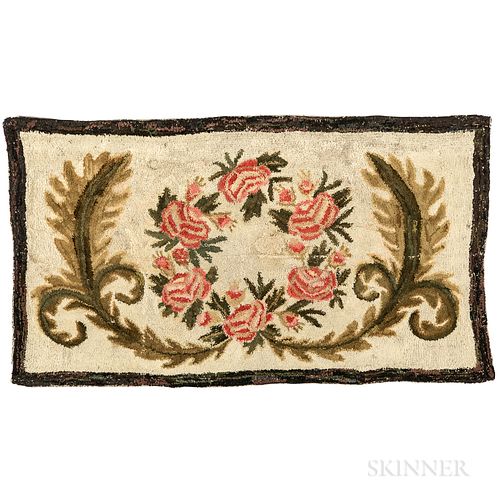 Floral Hooked Rug, America, 19th century, the central circular rose pattern within a wreath against a beige background and black/brown