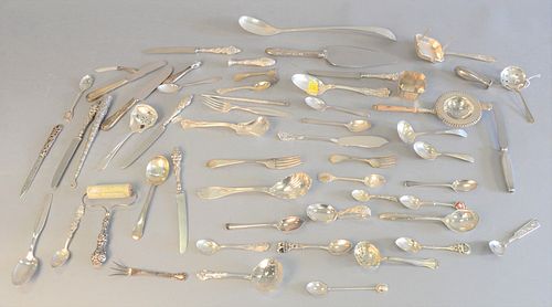 Sterling silver lot of various flatware along with twelve handles; two tea strainers; five Tiffany & Co. spoons, weighable 30.9 t.oz.