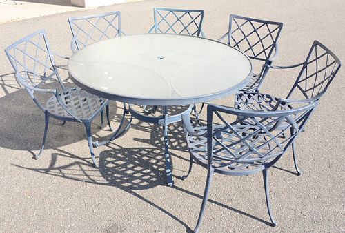 Twelve piece outdoor lot to include round glass top table, six chairs, loveseat, and four miscellaneous tables.