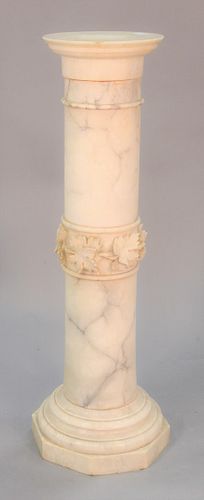 White marble pedestal, carved floral details to the base, in three pieces. 40-1/2" high, top 10-3/4" dia.