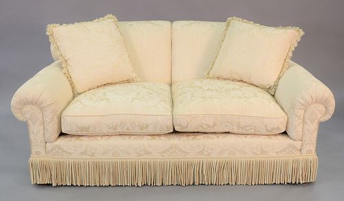 Custom two cushion white sofa, tassel details to the base. 33" x 72" x 38".