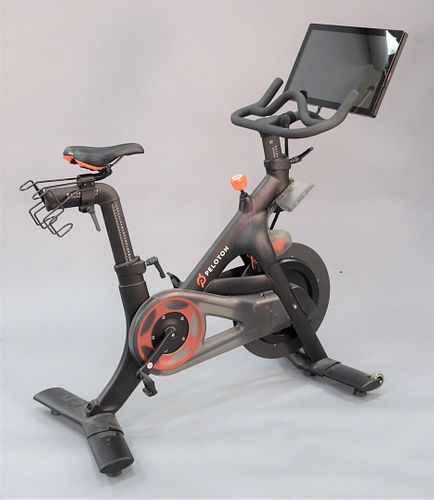First Generation Peloton Stationary bike, along with size 44 Peloton spin shoes., approximately 44" x 54" x 24".