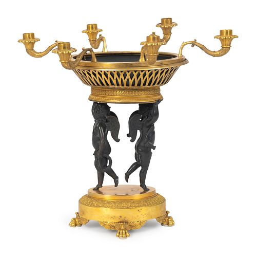 A Louis XVI Style Parcel-Gilt and Patinated Bronze Centerpiece
Height 18 1/2 x diameter 18 inches.