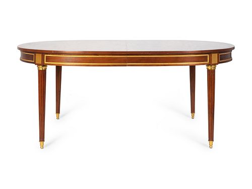 A Louis XVI Style Gilt-Bronze-Mounted Mahogany Extension Dining Table
Height 29 3/4 x length 72 1/2 x width 46 inches; with two 24 inch leaves.