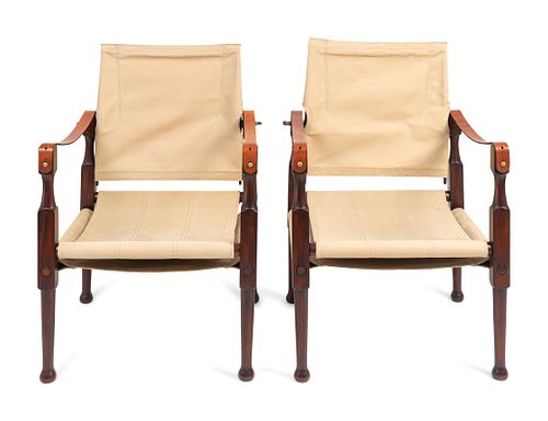 A Pair of British Colonial Style Mahogany, Canvas and Leather Strap Campaign Chairs
Height 34 x width 22 inches.
