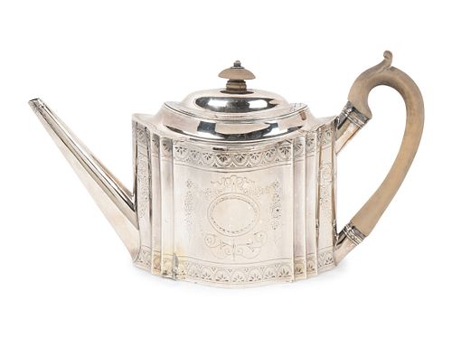 A Regency Silver Teapot
Height 6 1/2 x length 12 x width 4 3/4 inches.