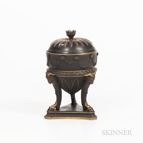 Wedgwood Gilded and Bronzed Black Basalt Urn and Cover, England, c. 1885, floral finial to a domed cover, the urn with floral festoons