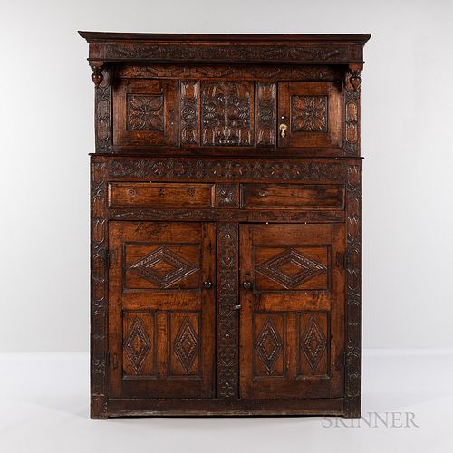 Carved Oak Cupboard, Netherlands, late 17th/early 18th century, recessed upper section with molded cornice, corner pendants, frieze car