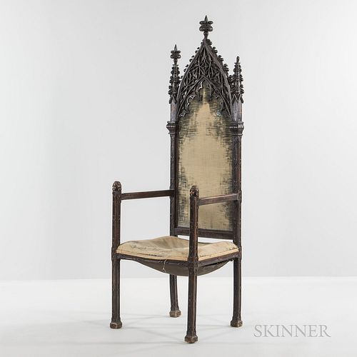 Gothic Revival Carved Armchair, 19th century, in the French style with carved tracery to seat back and frame, arm rests with carved hea