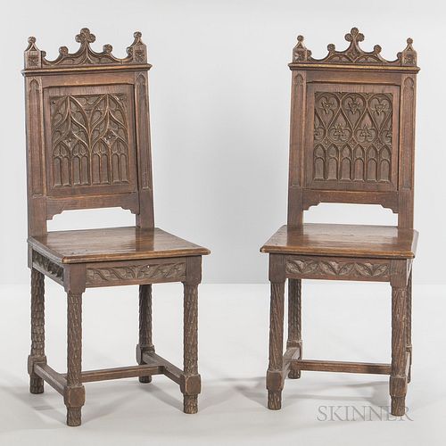 Six Gothic-style Oak Side Chairs, late 19th/early 20th century, each with a paneled back carved with gothic tracery, ht. 40, wd. 14 5/8