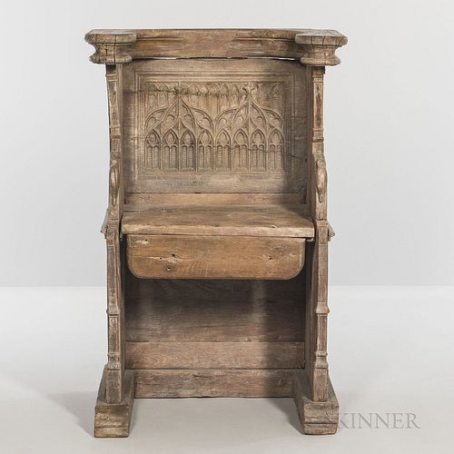 Gothic-style Carved Oak Choir Stall, late 19th/early 20th century, the hinged seat opening to a carved mask, ht. 42 1/4, wd. 27, dp. 20