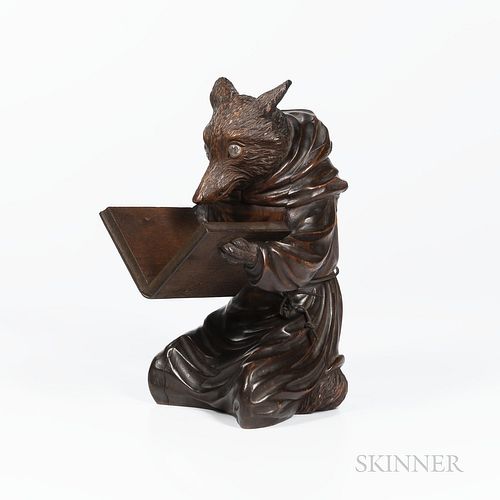 Black Forest Carved Fox, c. 1870, seated, wearing a monks robe and holding an open book, ht. 11 3/4 in.