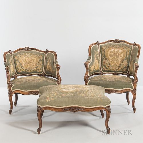 Louis XVI-style Walnut Seating Suite, with needlework upholstery, comprising two armchairs, ht. 29 1/2, wd. 27, dp. 21, and a footstool