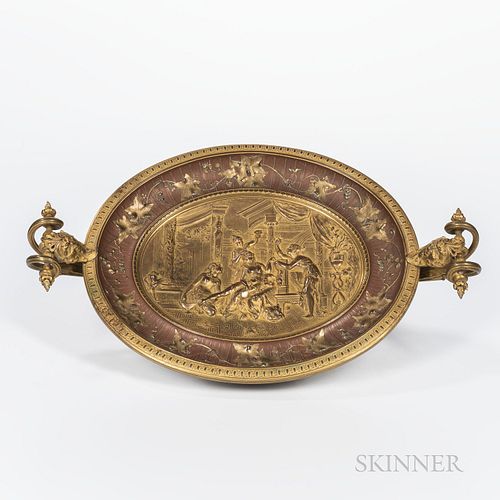 Gilt Bronze and Copper Oval Two-handled Dish, 19th century, masked supports to scrolled handles, foliate border surrounding an interior