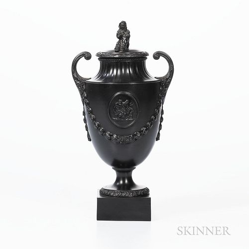 Wedgwood & Bentley Black Basalt Urn and Cover, England, c. 1780, Sybil finial and scrolled handles, raised classical medallion above la