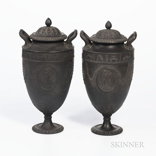 Two Wedgwood Black Basalt Zodiac Vases and Cover, England, c. 1880, a band of astrological motifs above floral festoons and oval medall