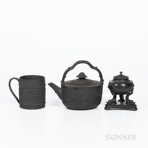 Three Wedgwood Black Basalt Items, England, 19th century, a cylindrical mug with wide oak leaf band, ht. 4 1/8; an oval shaped teakettl