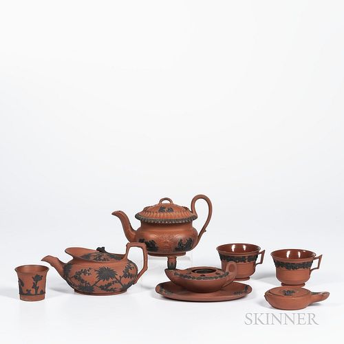 Seven Wedgwood Rosso Antico Items, England, 19th century, each with applied black basalt relief, including a prunus decorated parapet t