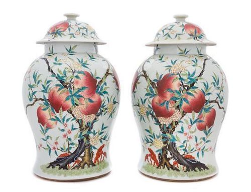 A Pair of Famille Rose Porcelain Baluster Vases and Covers Height of pair 16 inches.
