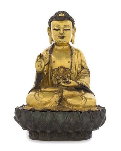 A Gilt Bronze Figure of Buddha Height overall 14 inches.
