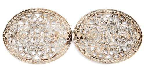 AN OVAL FILIGREE SILVER BUCKLE, the oval buckles each with 