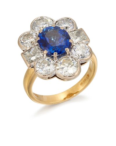 AN 18 CARAT GOLD SAPPHIRE AND DIAMOND CLUSTER RING, the ova