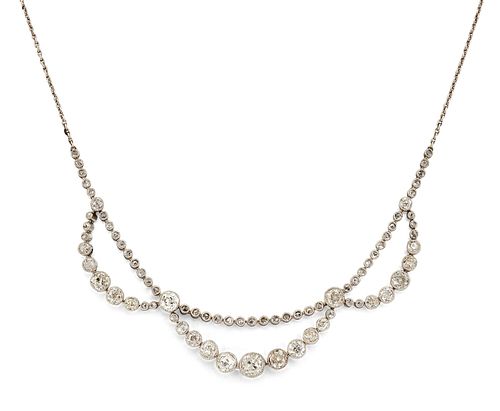 AN EDWARDIAN DIAMOND SWAG NECKLACE, the three central swags