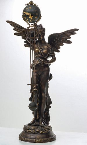 A REPRO BRONZE WINGED FIGURE WITH SEFIA MYSTERY CLOCK