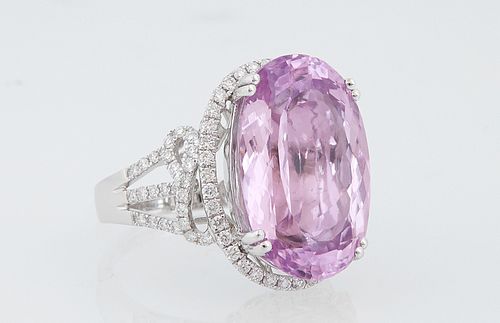 Lady's 14K White Gold DInner Ring, with a 20.99 ct. oval kunzite, atop a pierced border of round diamonds, flanked by diamond mounte...