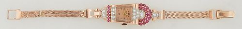 Lady's Art Deco 14K Rose Gold Bulova Dress Watch, c. 1940, of tapered trapezoidal form, the diamond mounted top with a round ruby mo...