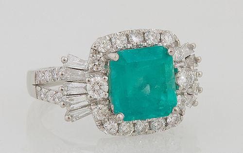 Lady's Platinum Dinner Ring, with a 3.73 ct. octagonal emerald, atop a border of round diamonds, flanked by baguette diamond mounted...