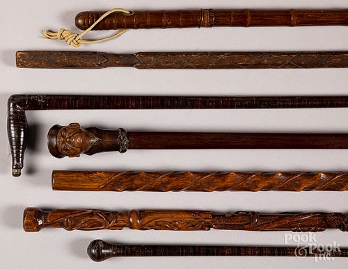 Seven assorted wood canes.