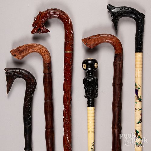 Six carved wood canes.