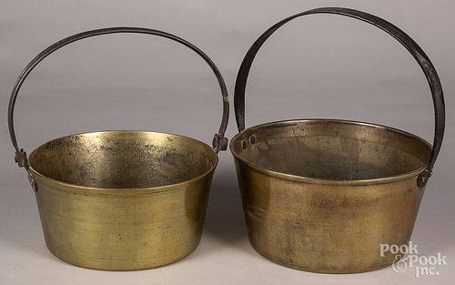 Seven brass and bell metal buckets and kettles