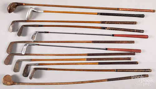 Twelve wood shaft golf clubs.