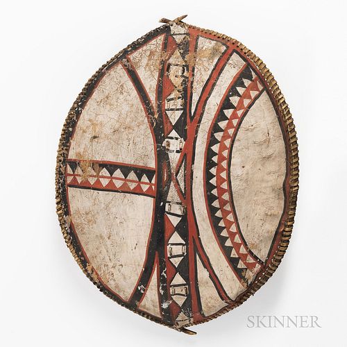 Maasai Shield, Kenya, made from buffalo hide, attached to a bent wood frame, convex in shape, with handle at rear attached by leather s